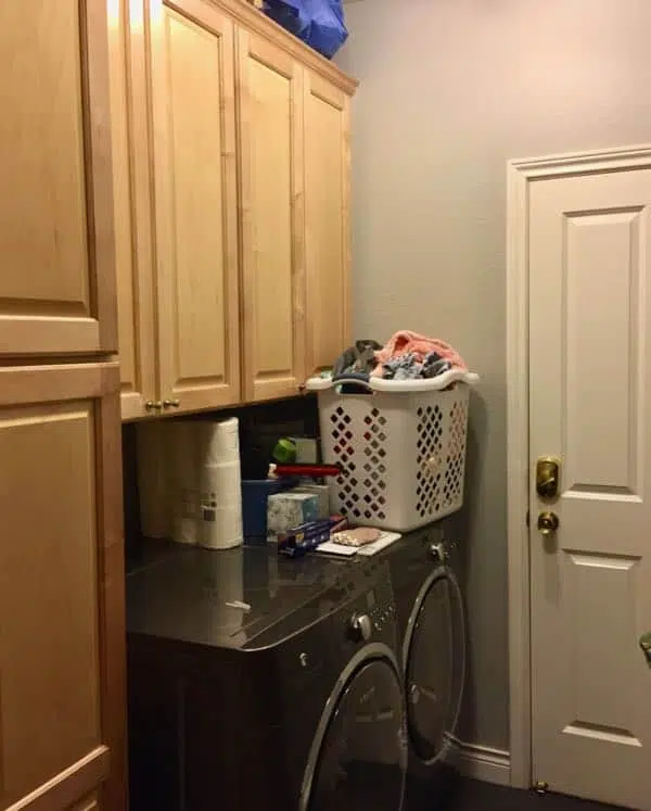 Laundry Room before with wood cabinets and gray walls.