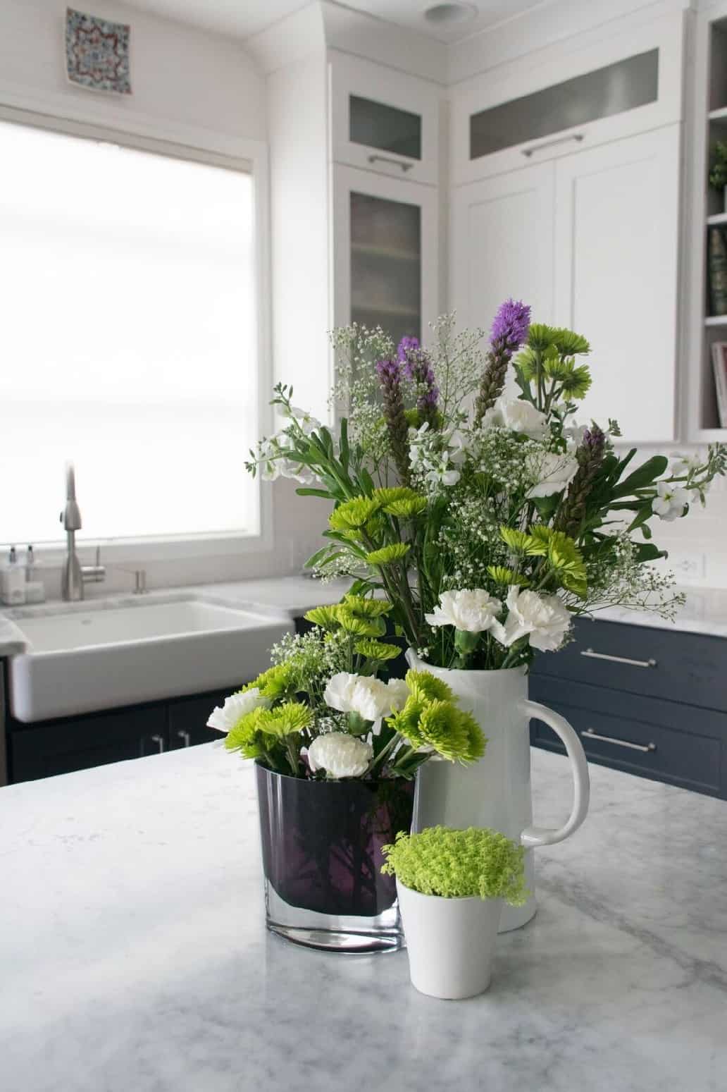 Classic kitchen with marble counters and farmhouse sink.