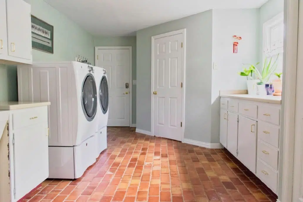 laundry room with washer and dryer and walls painted sw sea salt with trim, doors and cabinets painted sw extra white