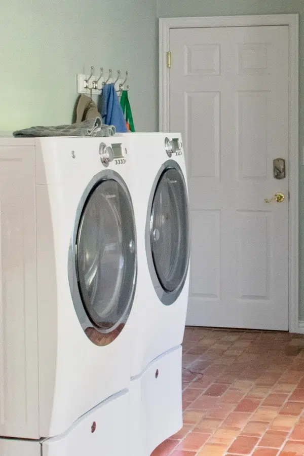 laundry room with washer and dryer and walls painted SW sea salt with doors painted sw extra white