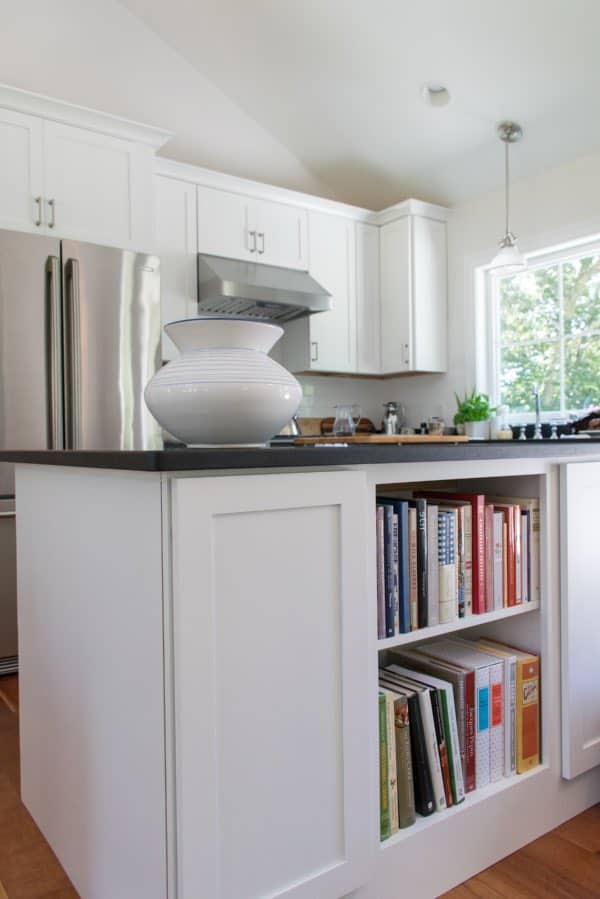 Classic white kitchen with bookshelves in island