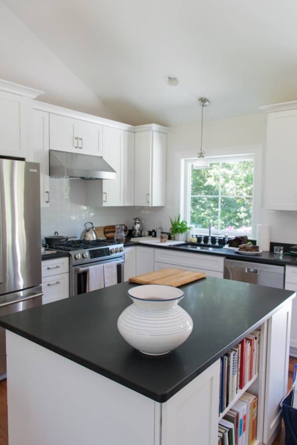 White kitchen with black granite counters and stainless appliances