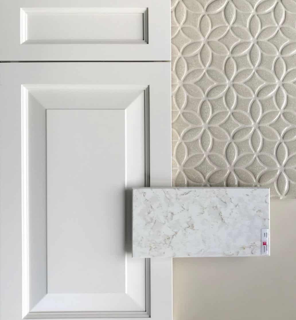 White cabinets with calacatta quartz and beige mosaic backsplash