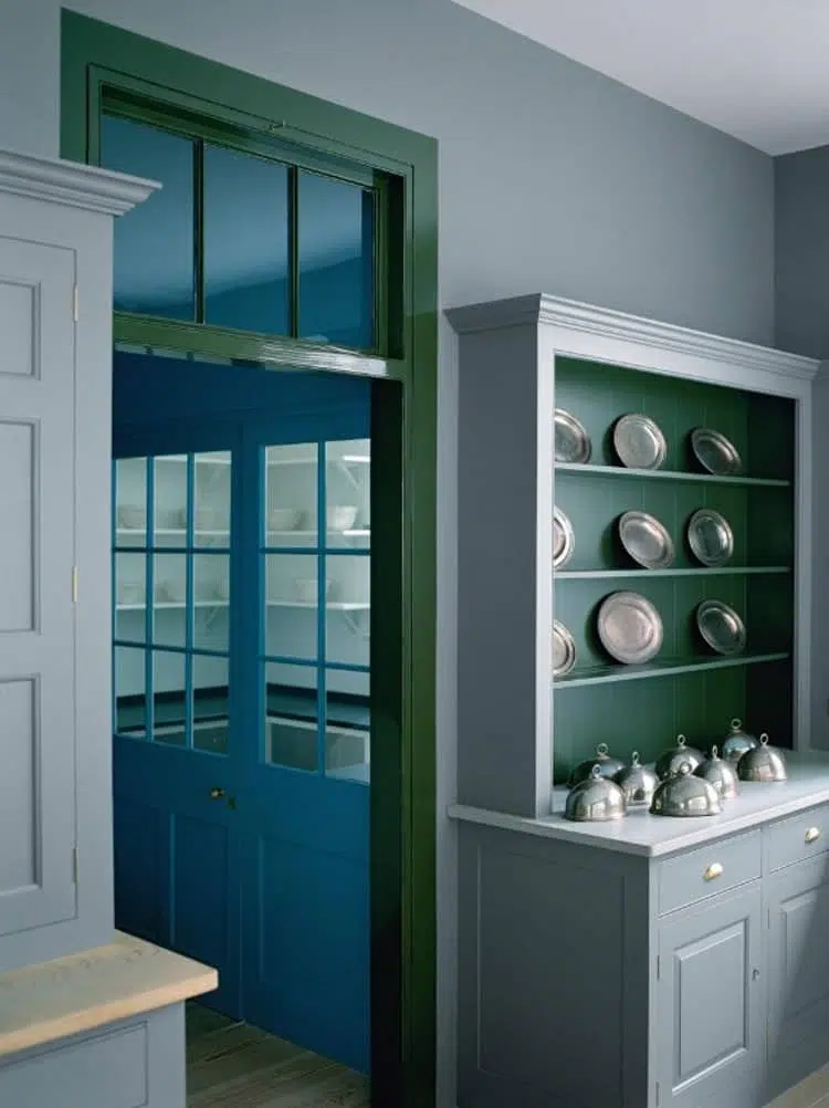 Blue and green butler's pantry with black counters