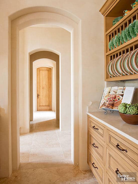 Butler's pantry with light wood cabinets and white counters