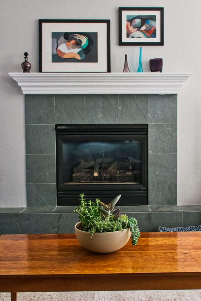 A fireplace is shown against a gray wall with eggshell paint sheen