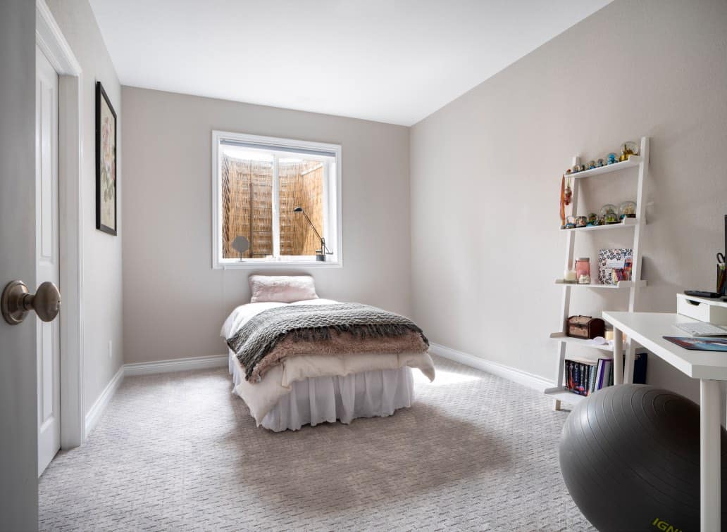 Girls basement bedroom with Abalone paint color and bamboo window well