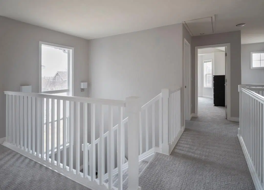 Landing with Gray walls and white stair railings