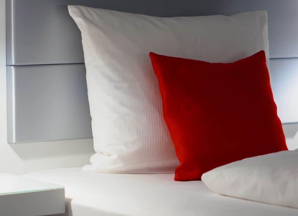 White and red pillows with headboard