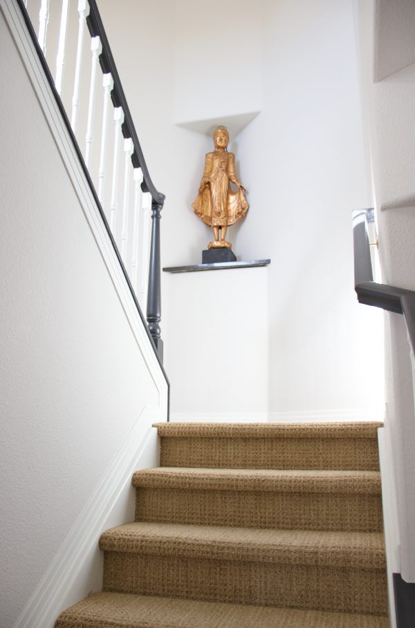 Classic Gray stairway with Simply white trim has buddha statue