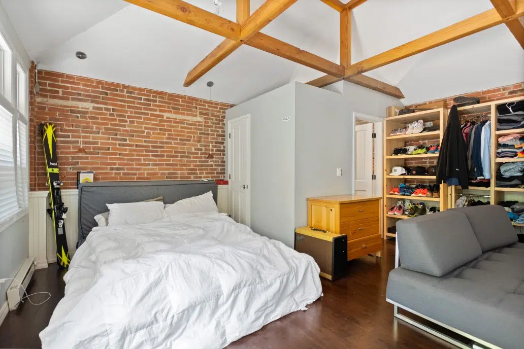 Bedroom painted with Shoreline walls and brick accent wall.