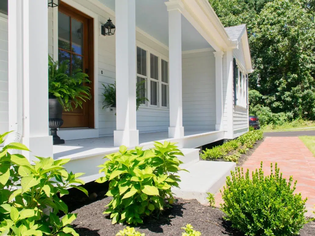 house with farmhouse white paint color and haint blue ceiling