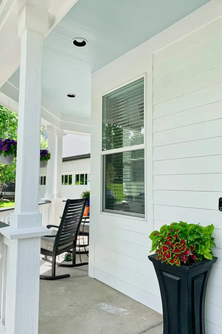 house with farmhouse white paint color and haint blue ceiling