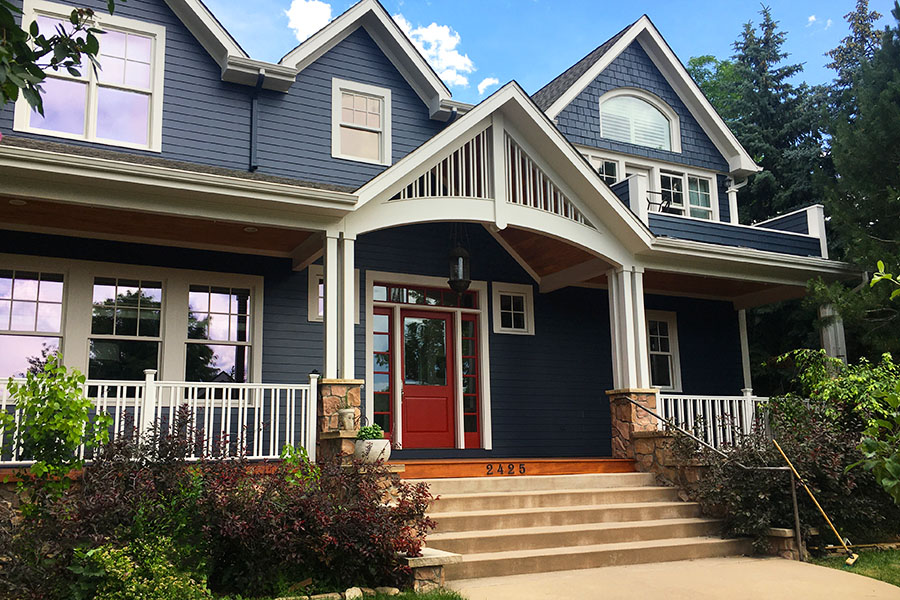 Blue house with white trim and red front door