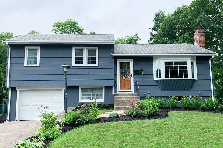 Dark blue and medium blue house with white trim and garage door.