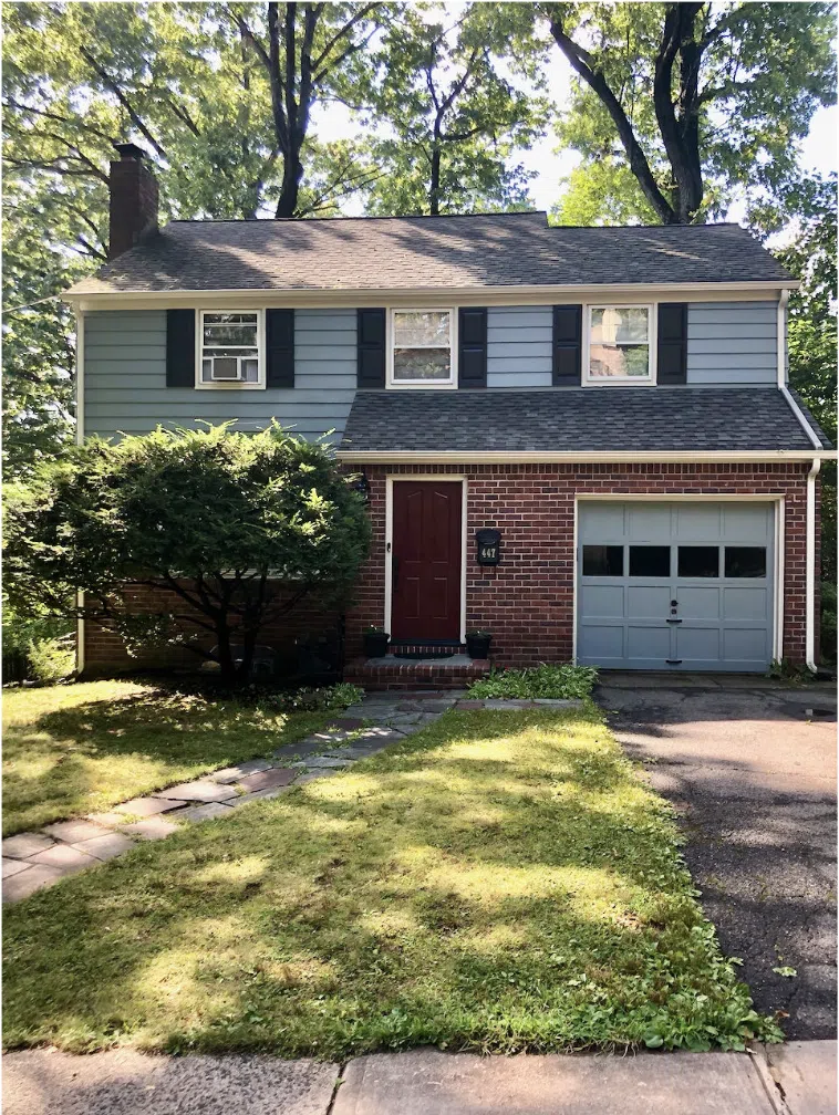 A home is painted with BM Brewster Gray, one of the best blue exterior paint colors.