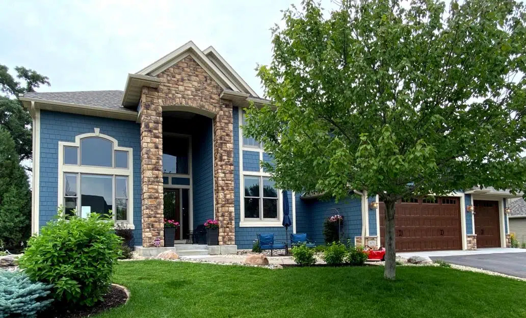 Blue exterior paint color palette with wood front door and garage door