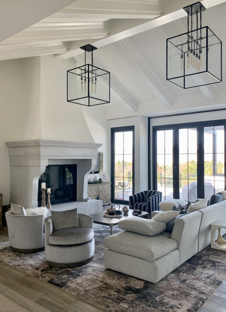 A large living room with tall windows is painted with Benjamin Moore Cloud White paint.