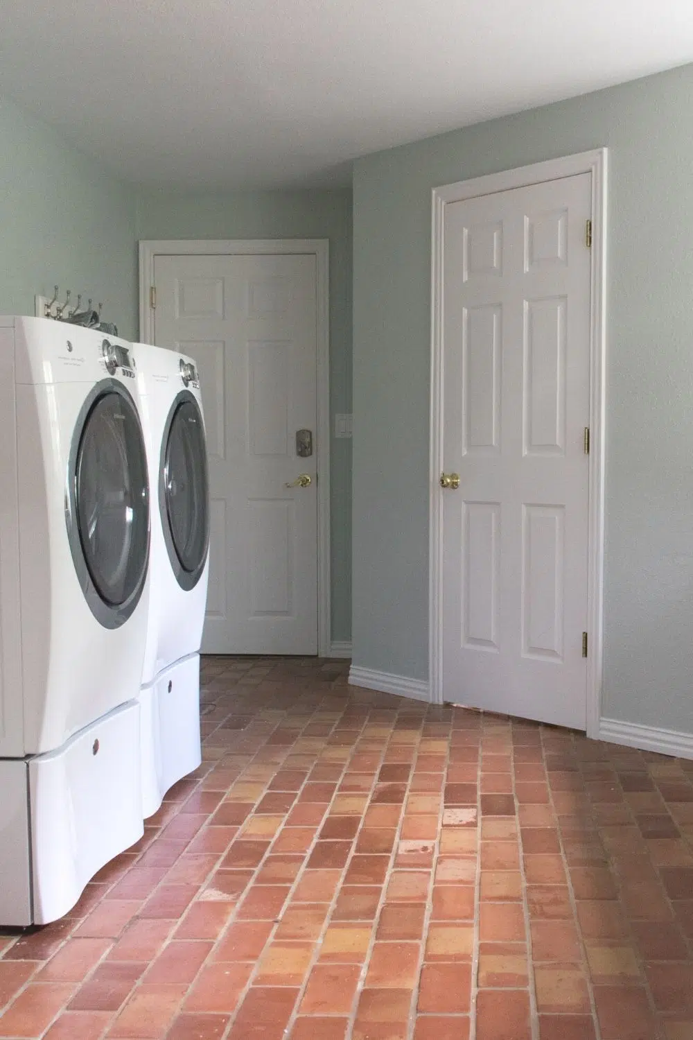 Laundry room with SW Sea Salt walls and terra cotta floors