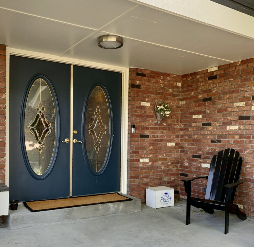 Blue front doors in red brick entry painted with SW Sea Serpent front doors