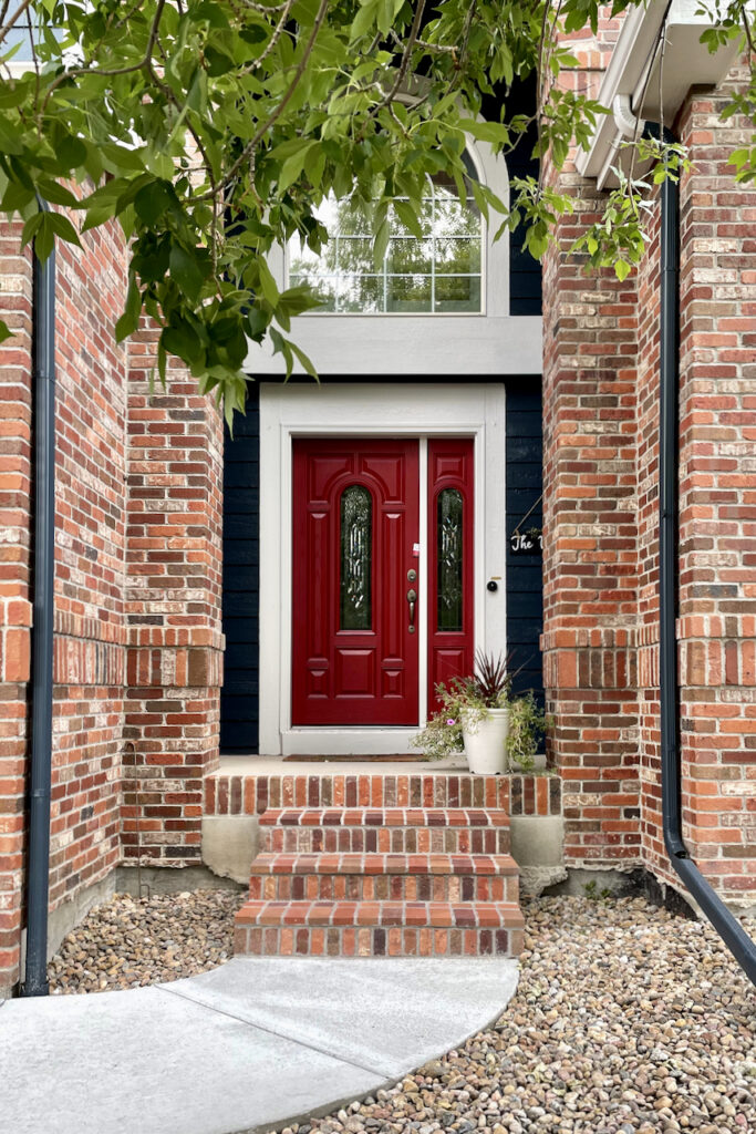 Red brick entry with red front door painted SW Stolen Kiss