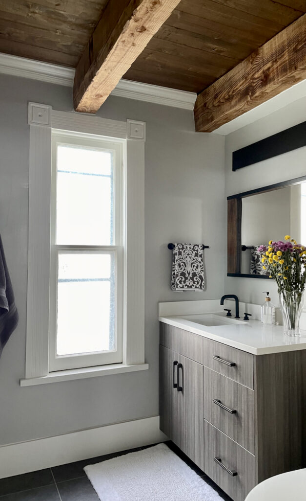 North facing bathroom with Repose gray walls, wood beams and white trim