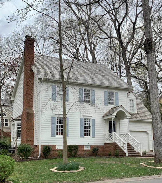 White house with red brick painted with SW Oyster White and Cyberspace front door