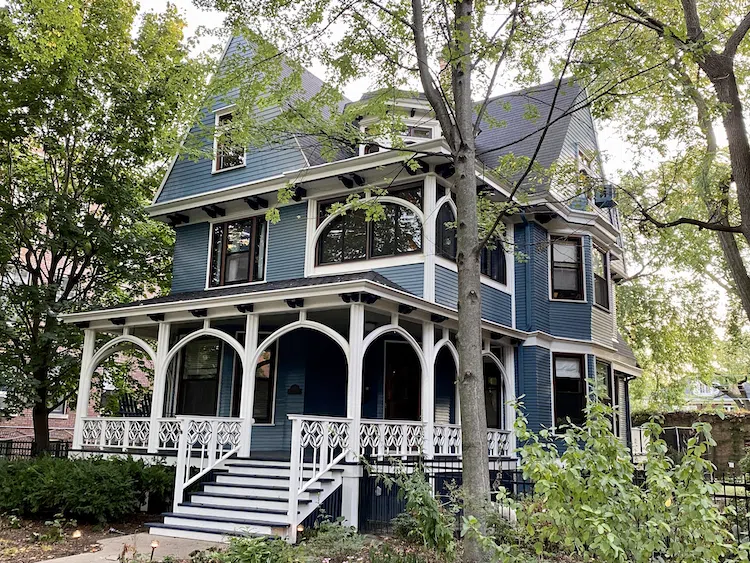 Blue victorian house with white dove trim