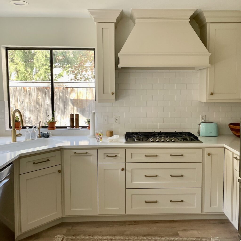 This bright kitchen features painted cabinets with Benjamin Moore Edgecomb Gray.