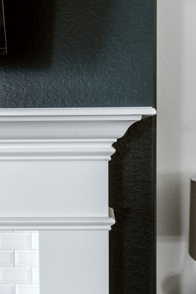 This Hague Blue fireplace bump-out features an off-white trim paint on the mantle and white brick.