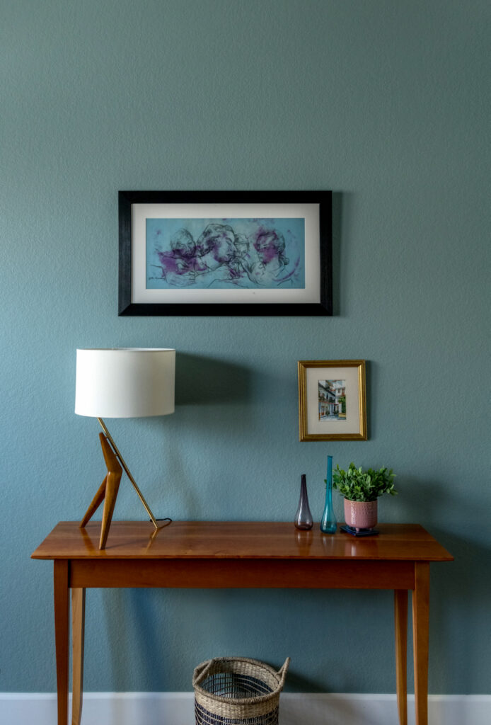 A console table stands in front of an Oval Room Blue wall