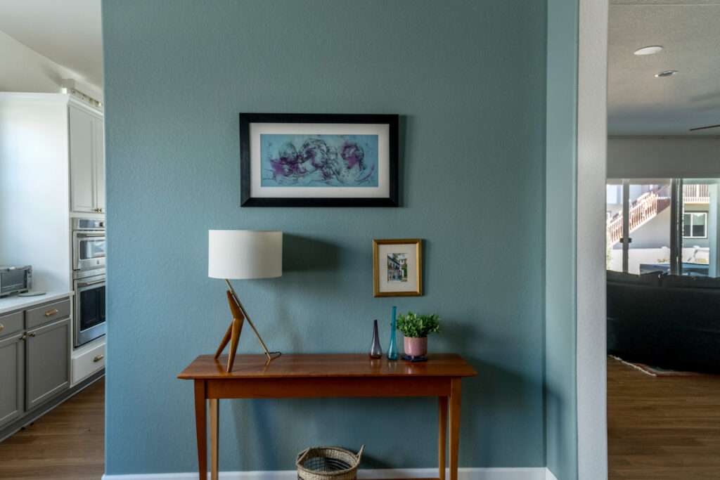 An accent wall with console table painted with Farrow & Ball's Oval Room Blue