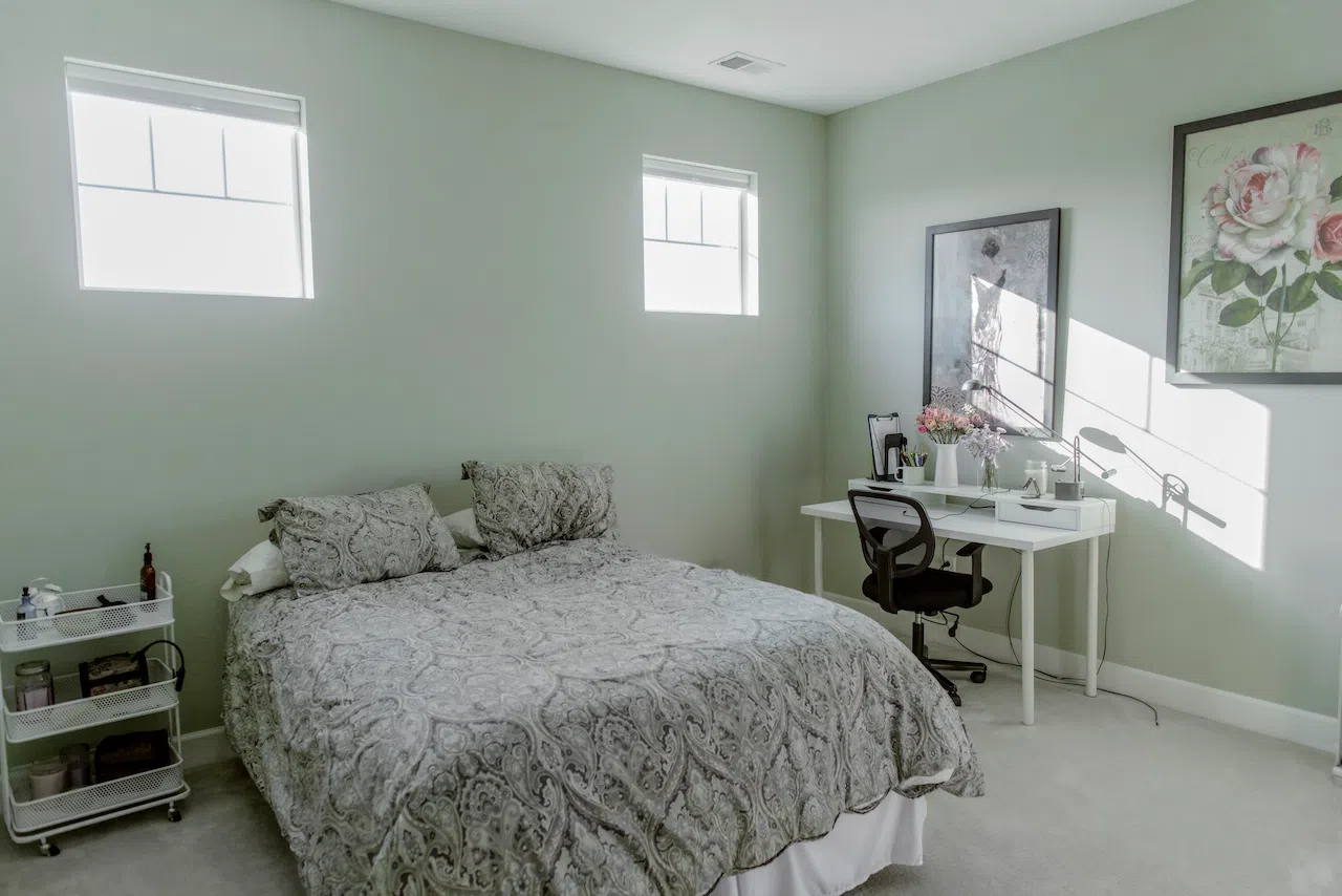 A bedroom is painted with Farrow & Ball Cromarty paint