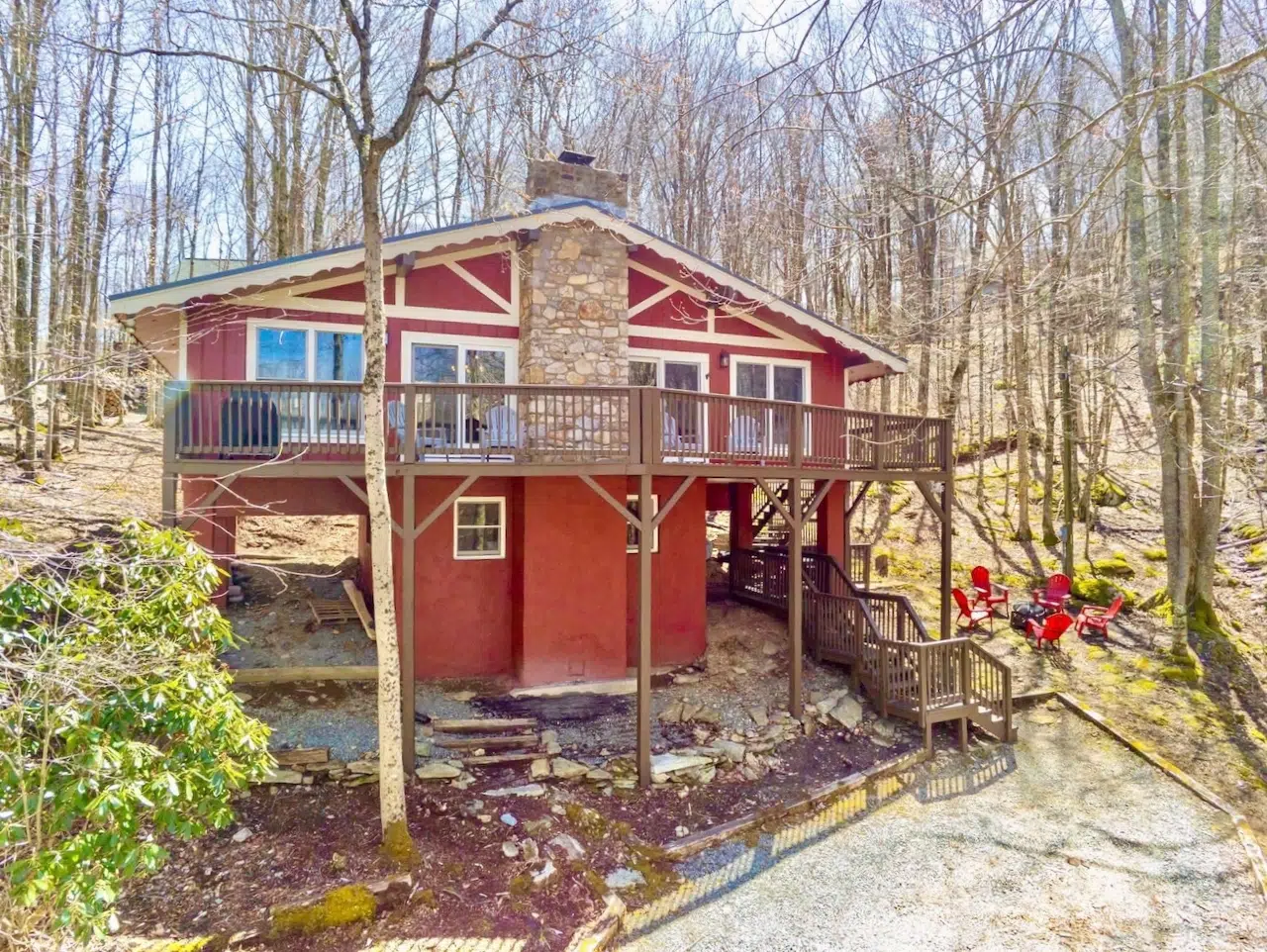 A home in the woods painted with Sherwin-Williams Rustic Red paint