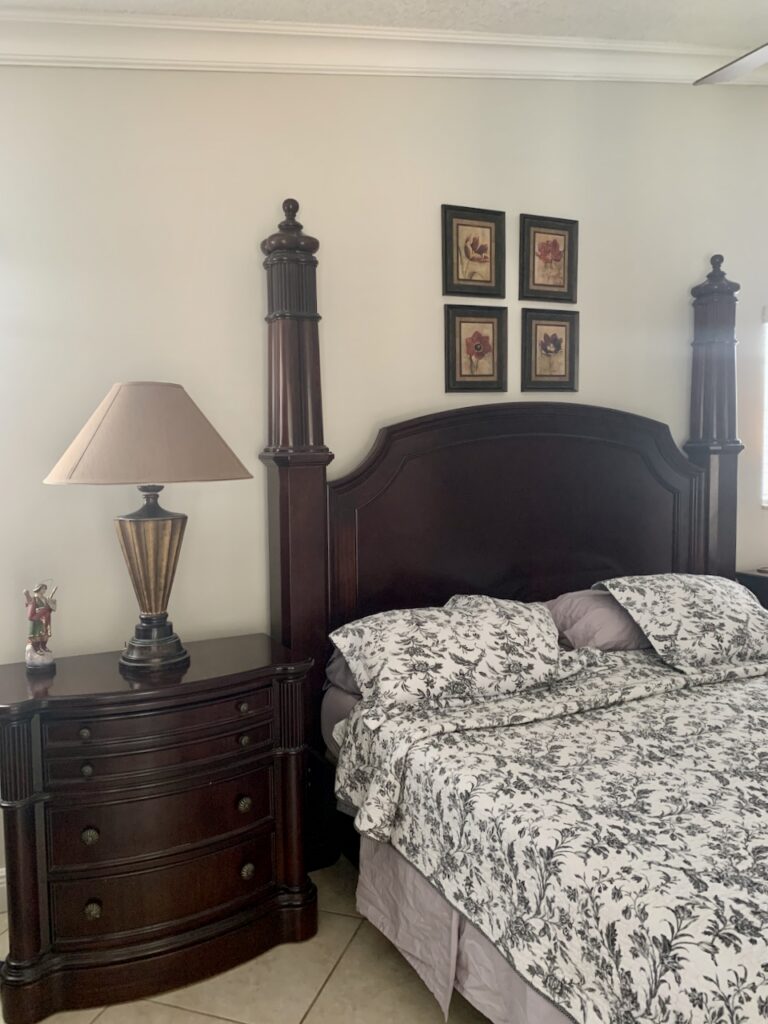 A bedroom wall is painted with Benjamin Moore Pale Oak paint.