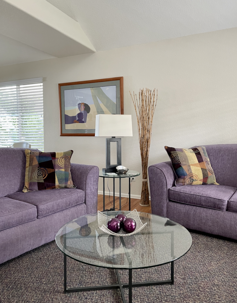 Purple couches in a Gray Mist living room as part of a whole house paint color scheme