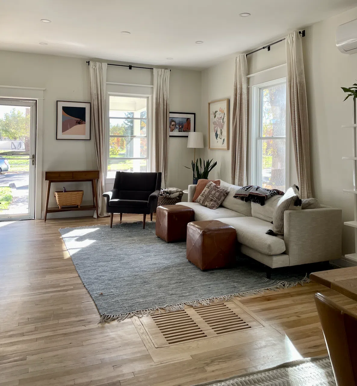 A living room painted white as part of a whole house color palette