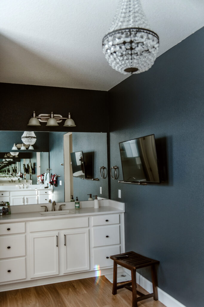 A Sherwin-Williams Cyberspace bathroom wall with white vanity