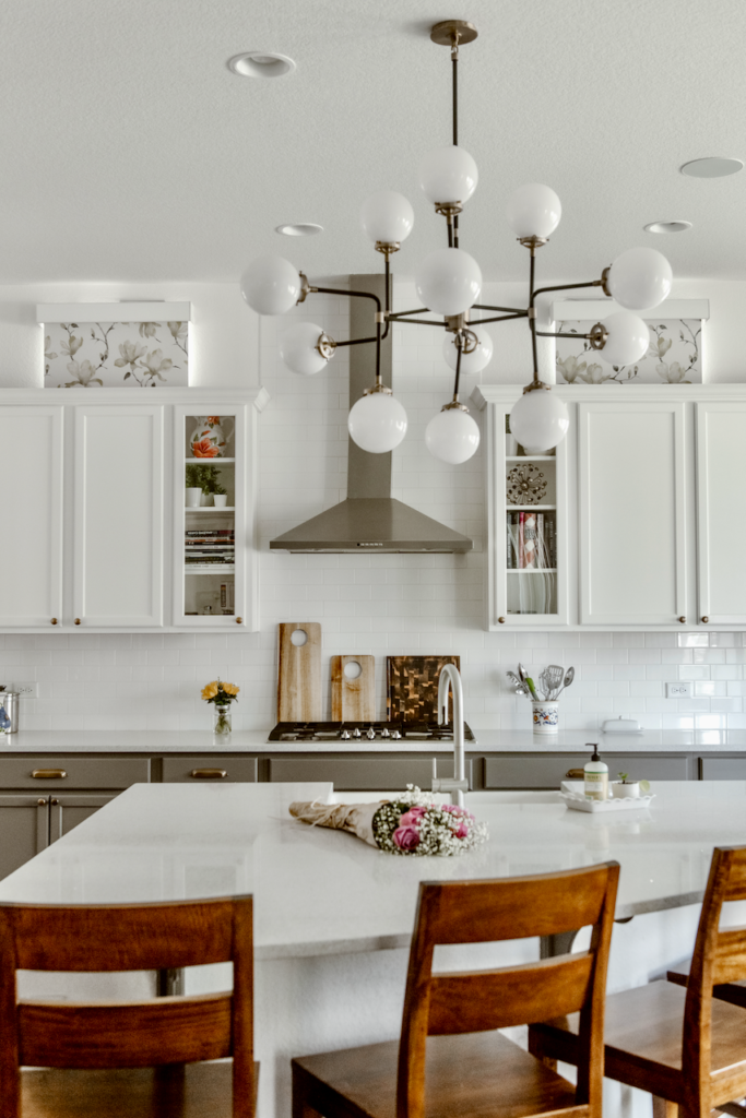 Patterned window treatments in a white and gray kitchen