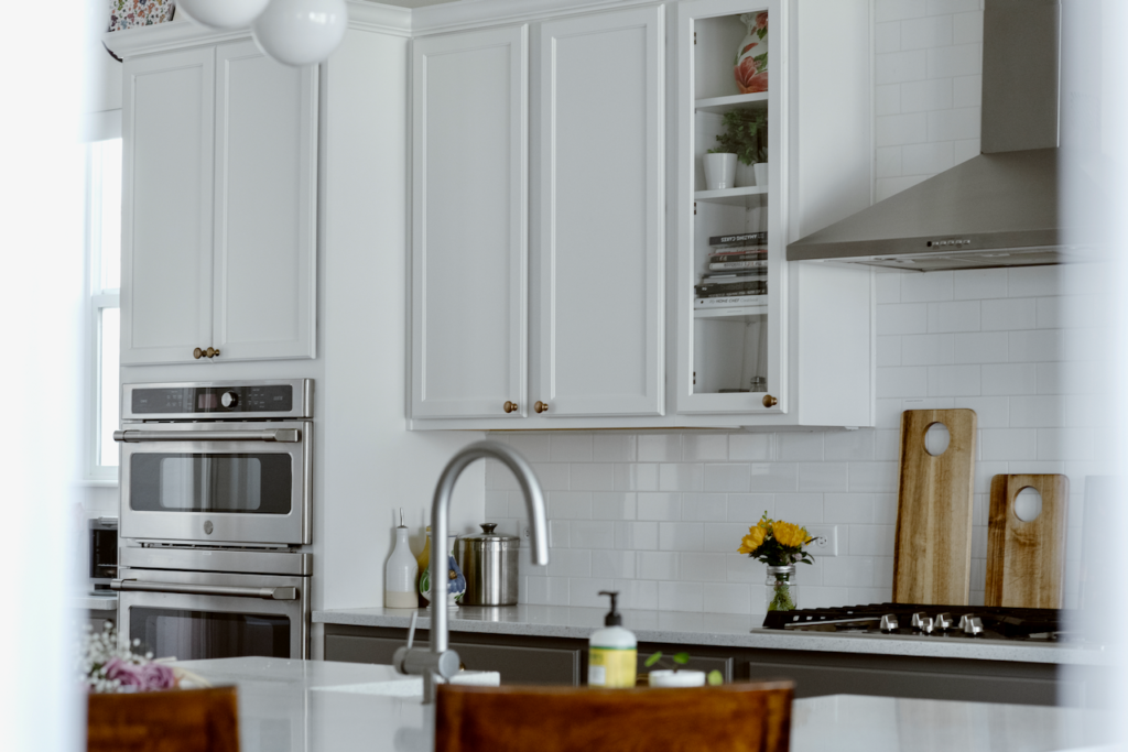 White subway tiles on a wall of kitchen kitchen cabinets