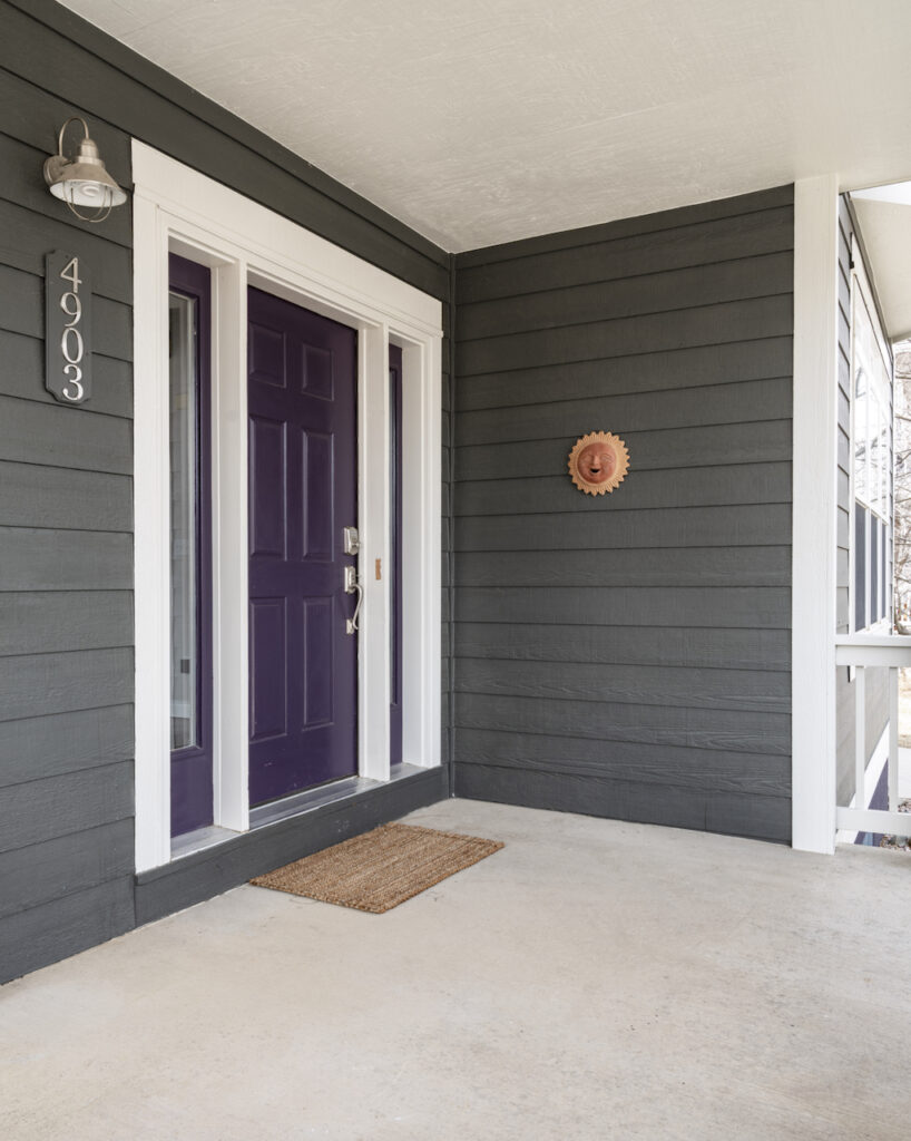 A deep purple front door is painted with Benjamin Moore Tulsa Twilight. 