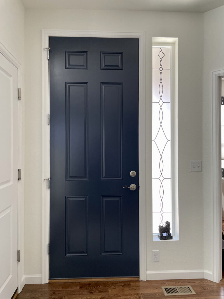 An entryway with SW Greek Villa paint and BM Hale Navy front door