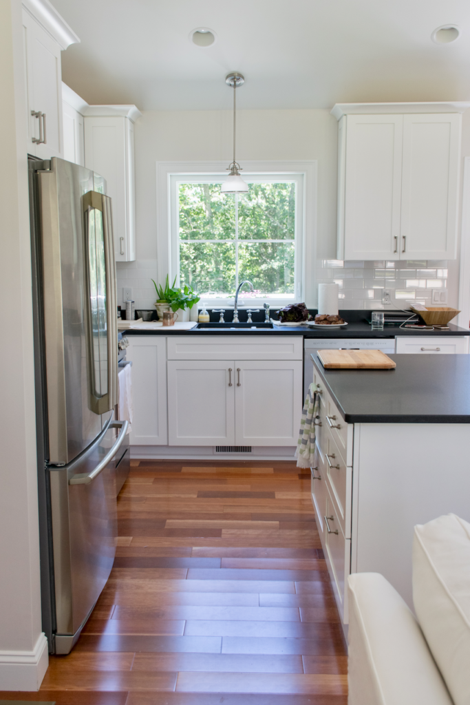 SW Extra White kitchen cabinets with warm natural wood floors