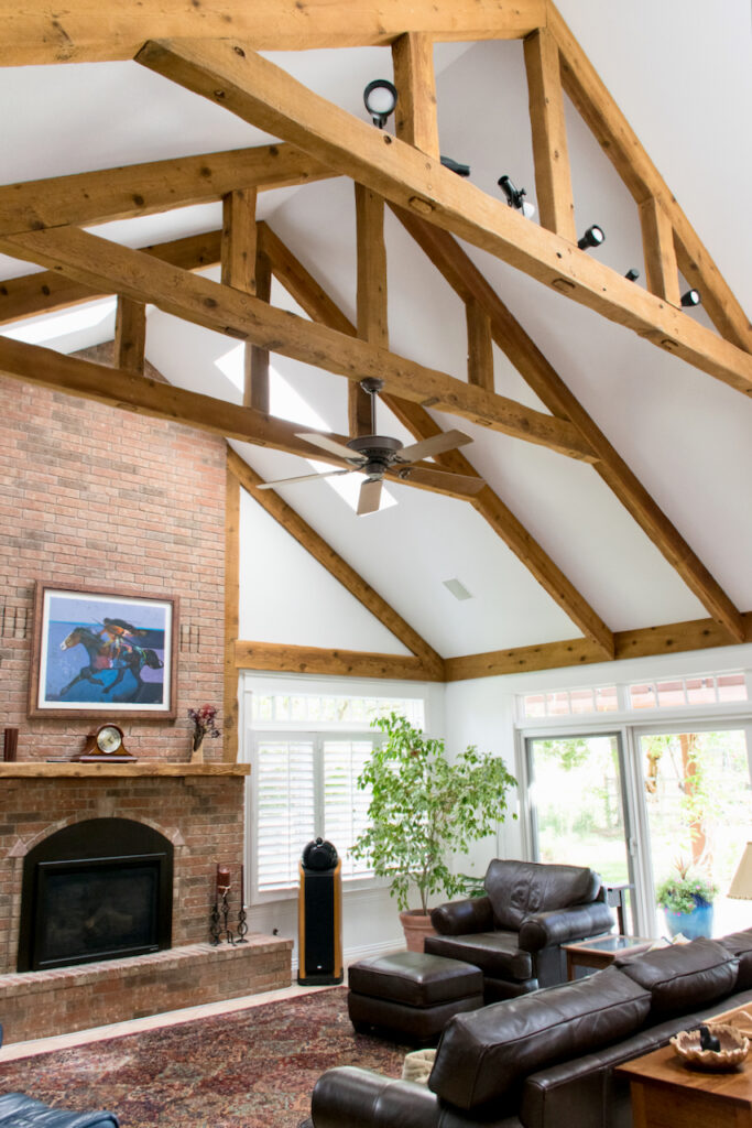 A family room with wood beams, high ceilings and SW Extra White wall paint 