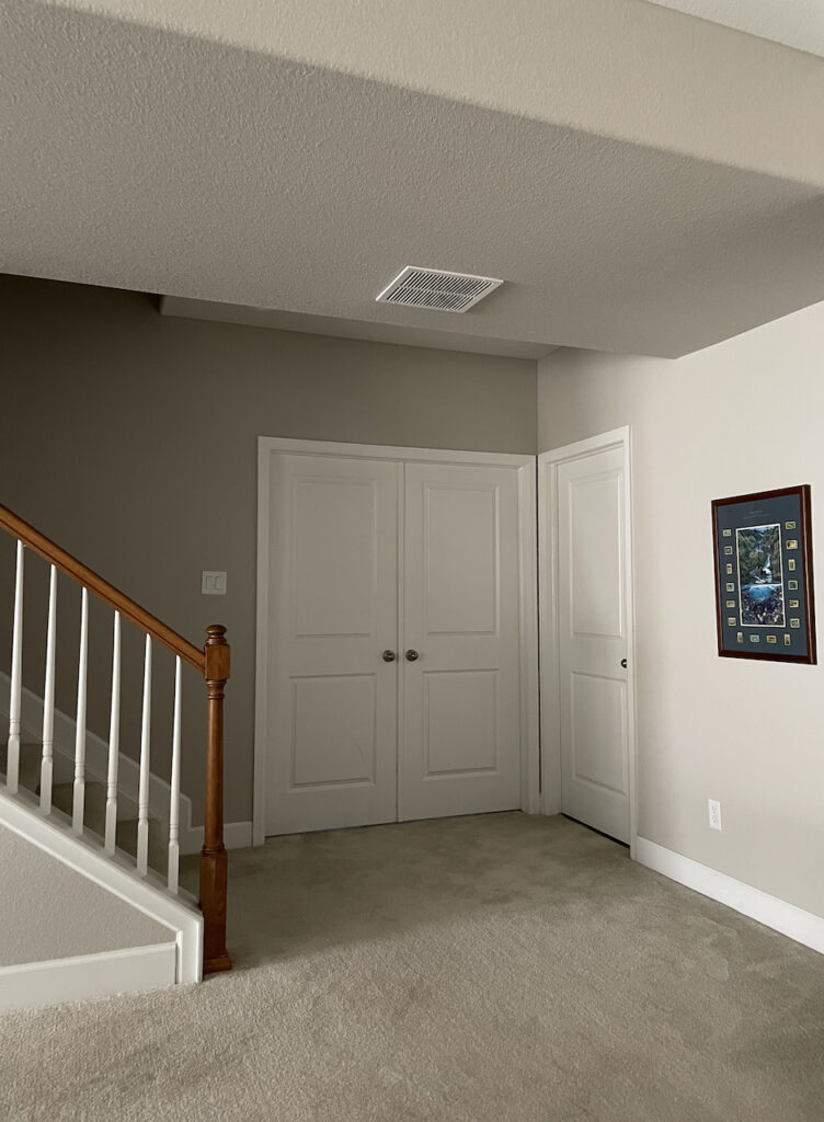 A basement rec room is painted with SW Agreeable Gray, one of the best basement paint colors. 