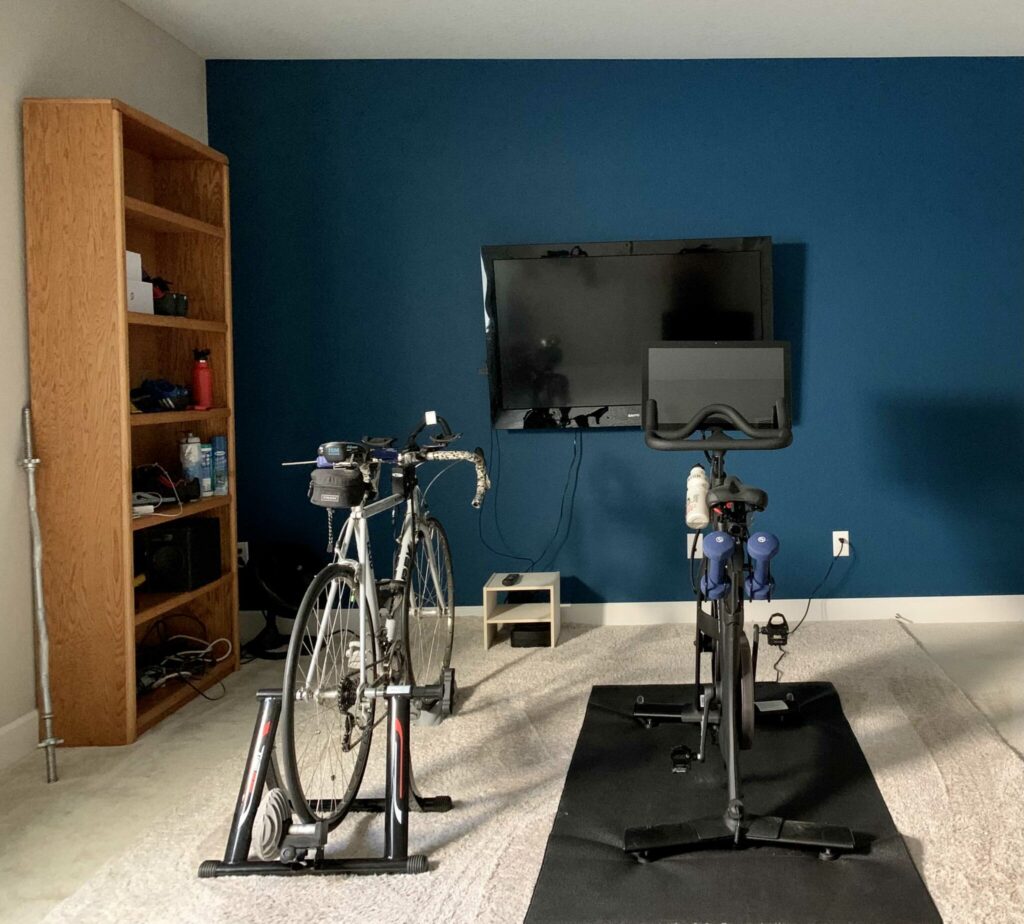 A basement gym features a BM Slate Teal accent wall