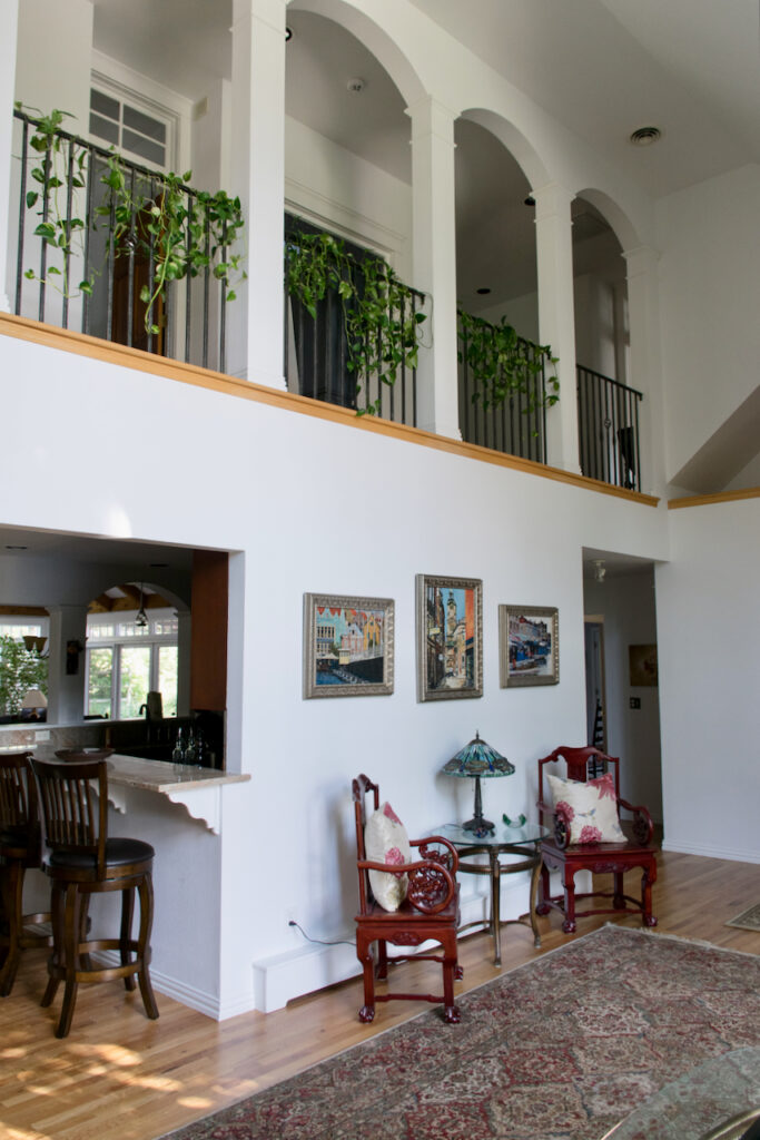 A large living room with high ceilings painted with SW Extra White paint.