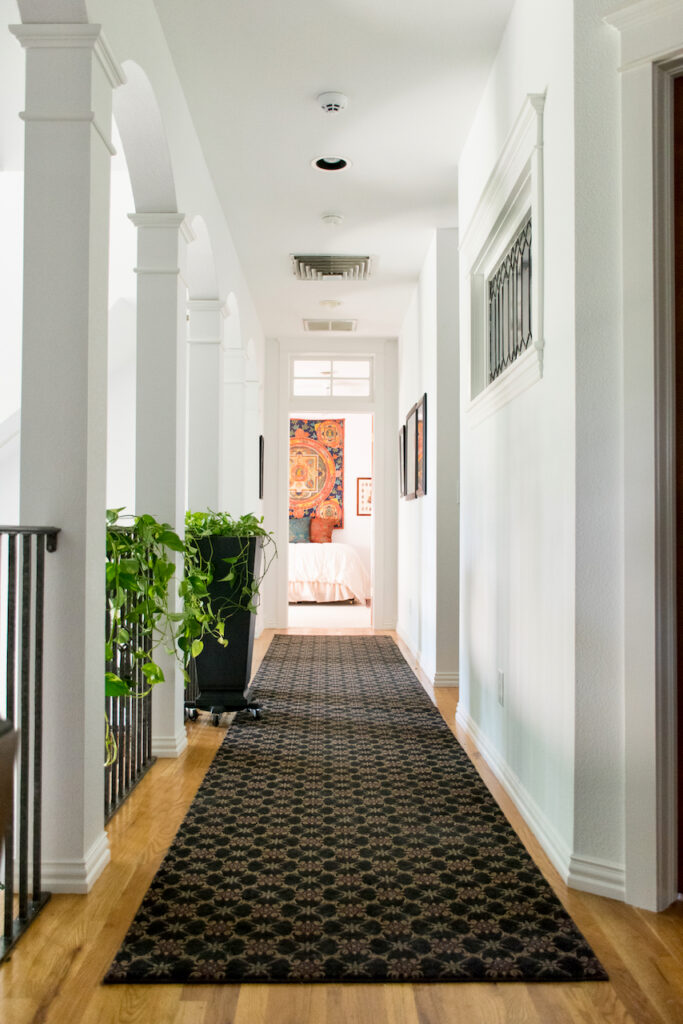 A hallways features Sherwin-Williams Extra White wall color and trim.