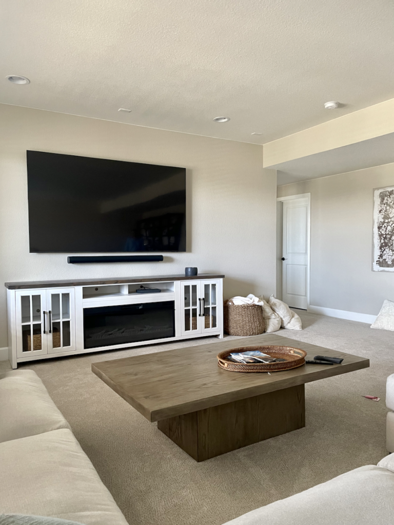 A basement living room painted with Sherwin-Williams Accessible Beige paint. 
