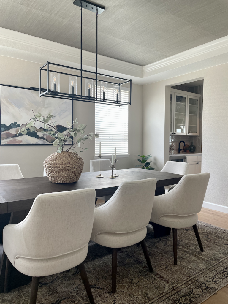 A dining room painted with Sherwin-Williams Accessible Beige paint. 